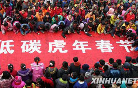 近日,山东省枣庄市回民小学学生在倡导过环保“低碳”虎年春节的条幅上签名。新华社发(孙中喆 摄) 近日,山东省枣庄市回民小学学生在倡导过环保“低碳”虎年春节的条幅上签名。新华社发(孙中喆 摄)